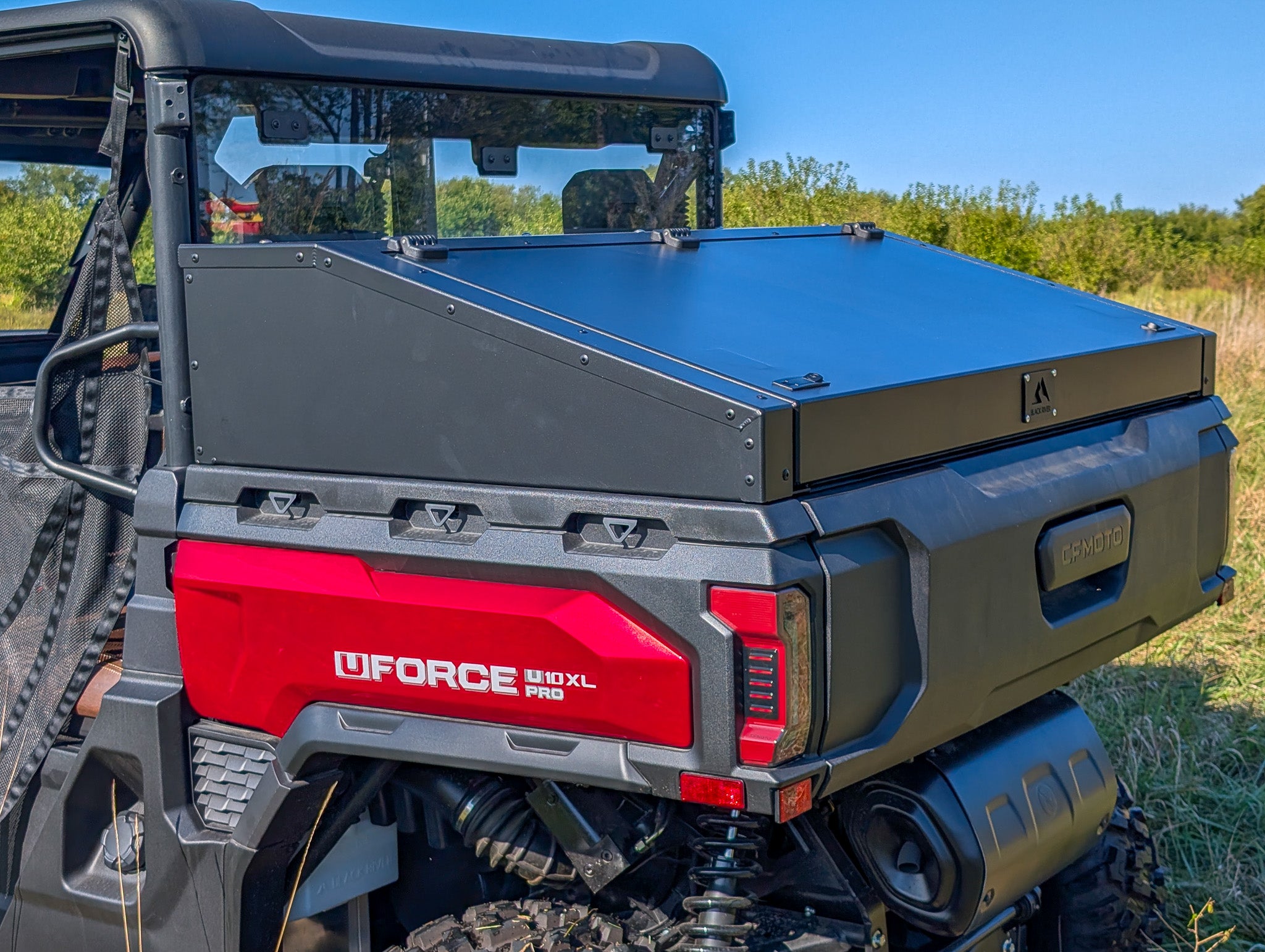 CF Moto UTV with a storage box on a grassy field