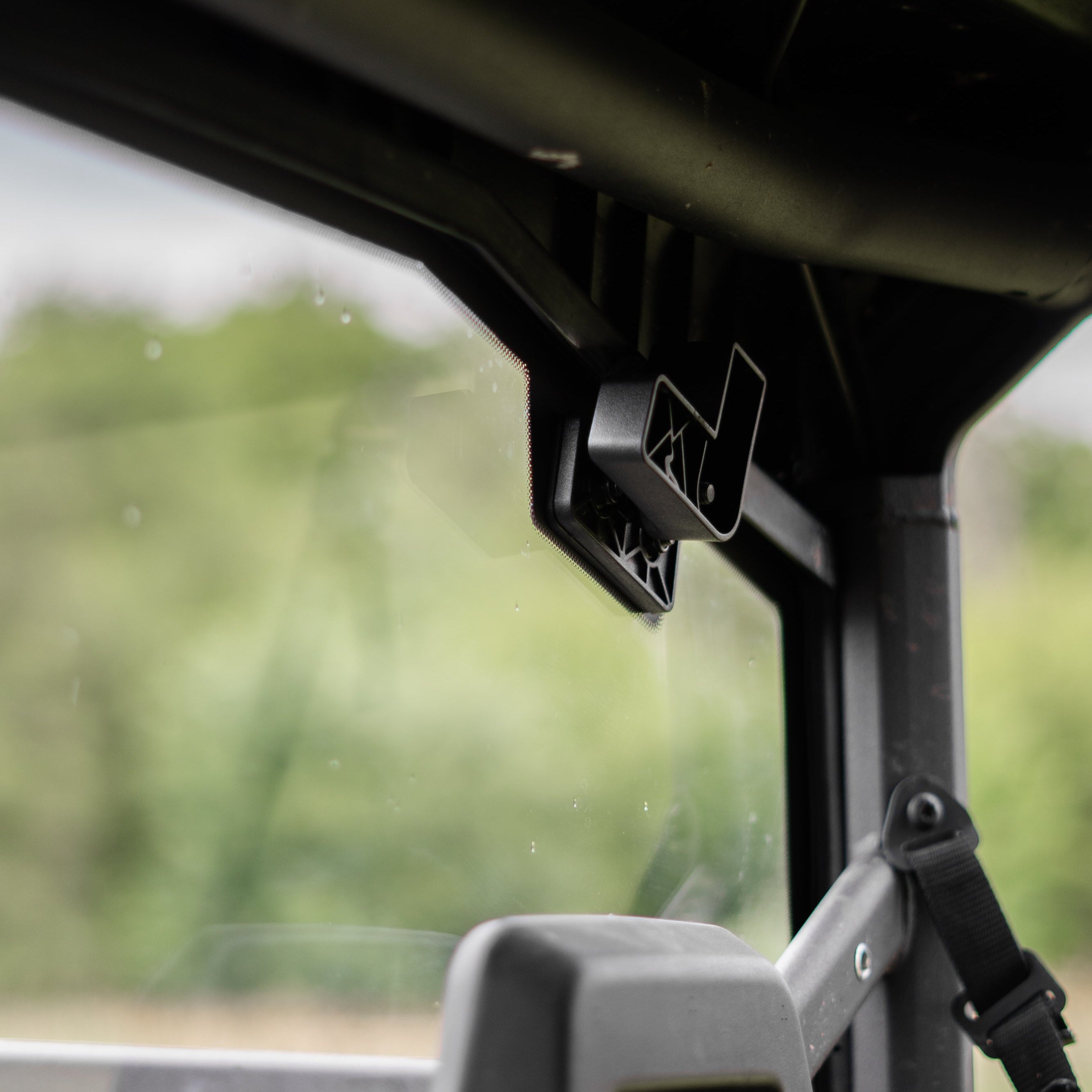 Close-up of a UTV's interior with a rear glass mount