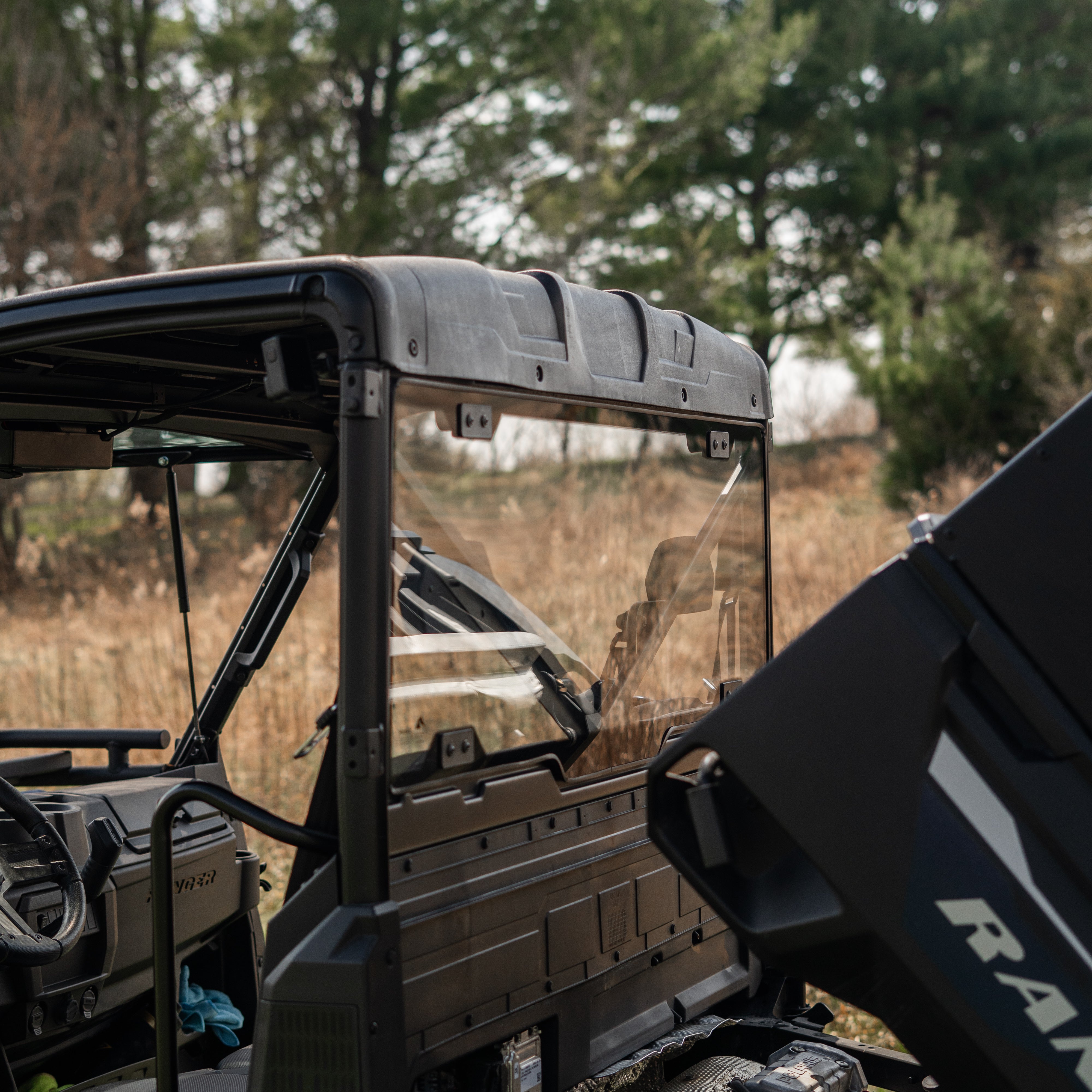 A rear glass window attached to a vehicle, providing visibility to the vehicle's interior and exterior environment.