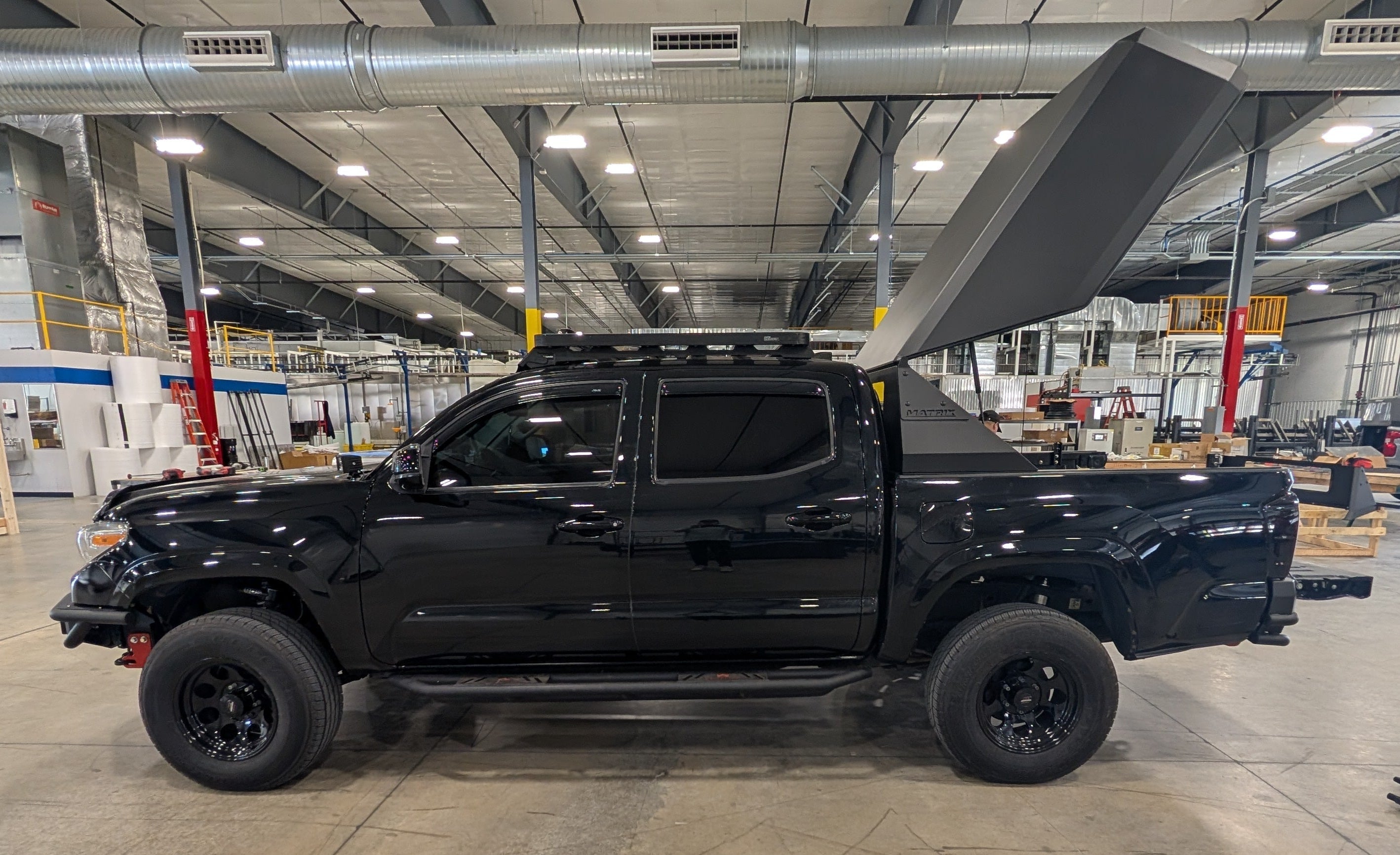 Black pickup truck in a warehouse setting