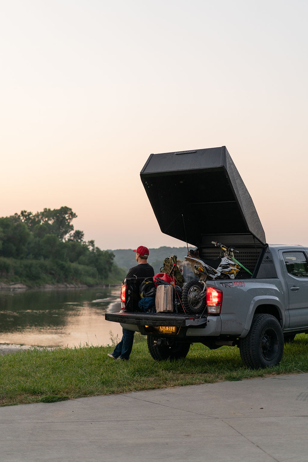 man looking at pond with a truck topper for a toyota tacoma