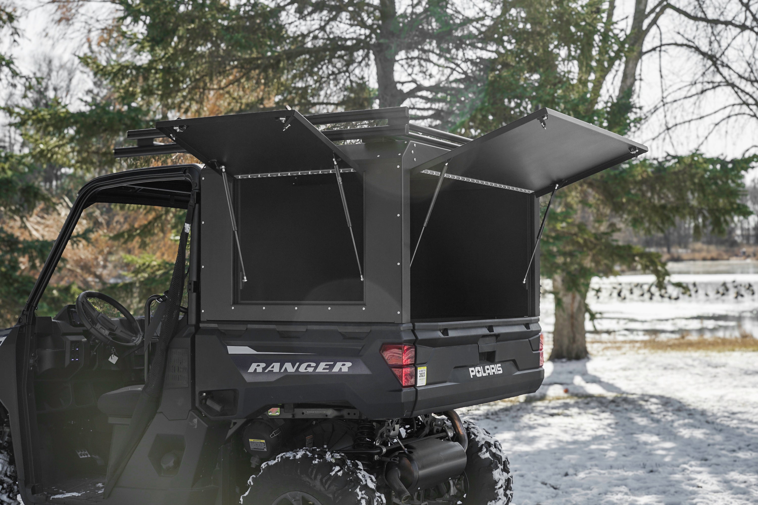 rebel box and rebel roof rack shown installed on a utv with doors open